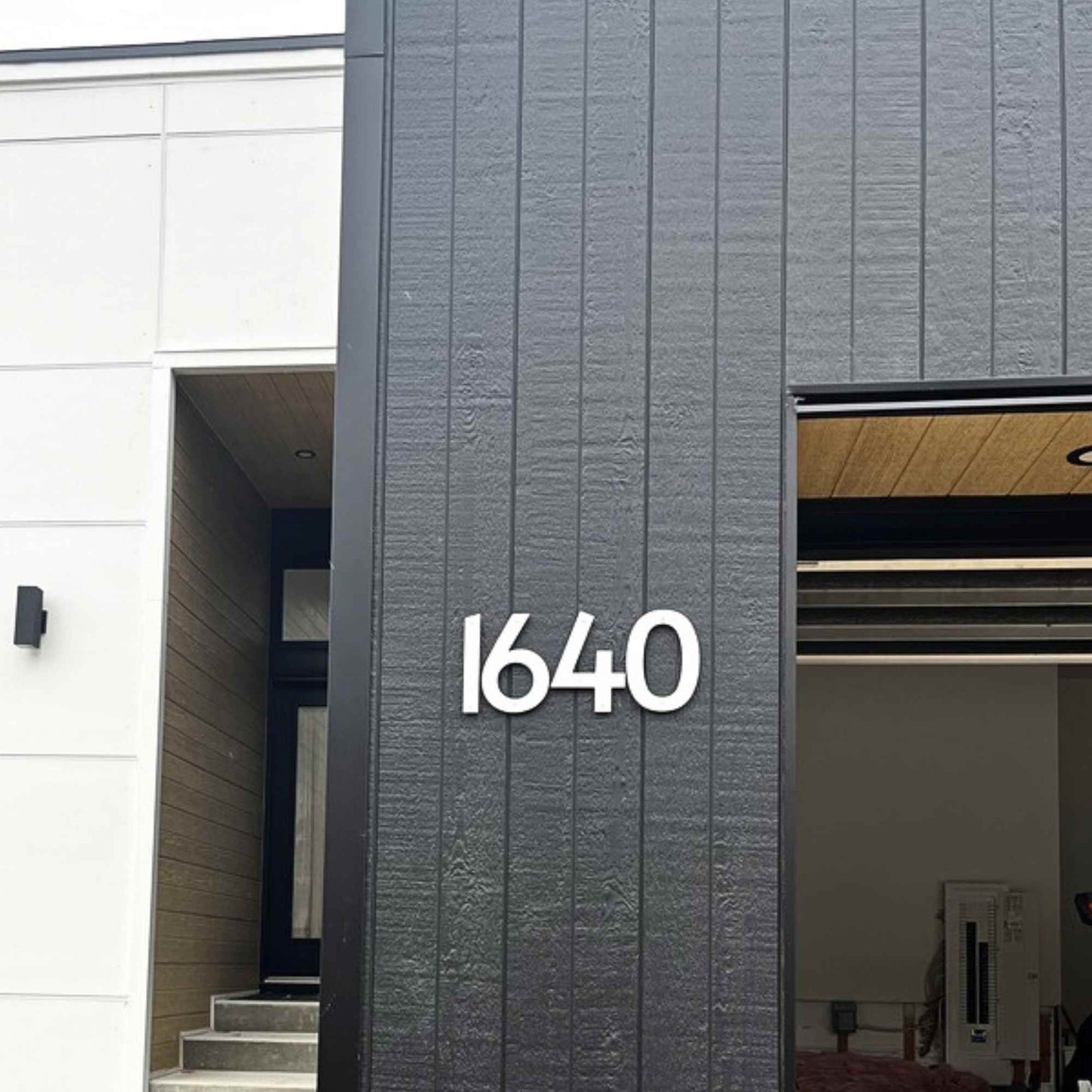 Modern building exterior with number '1640' on a gray facade