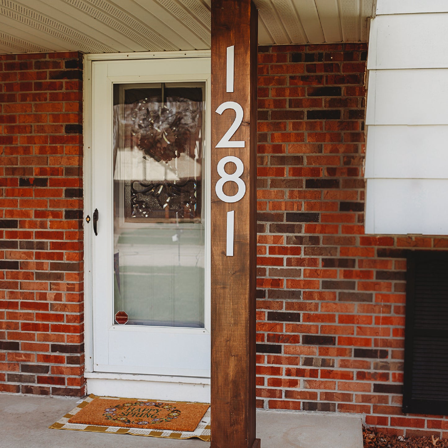 Classic Modern white house numbers on front porch post