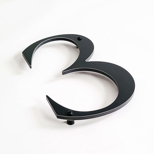 ROMAN SERIF house number close up detail with standoffs.