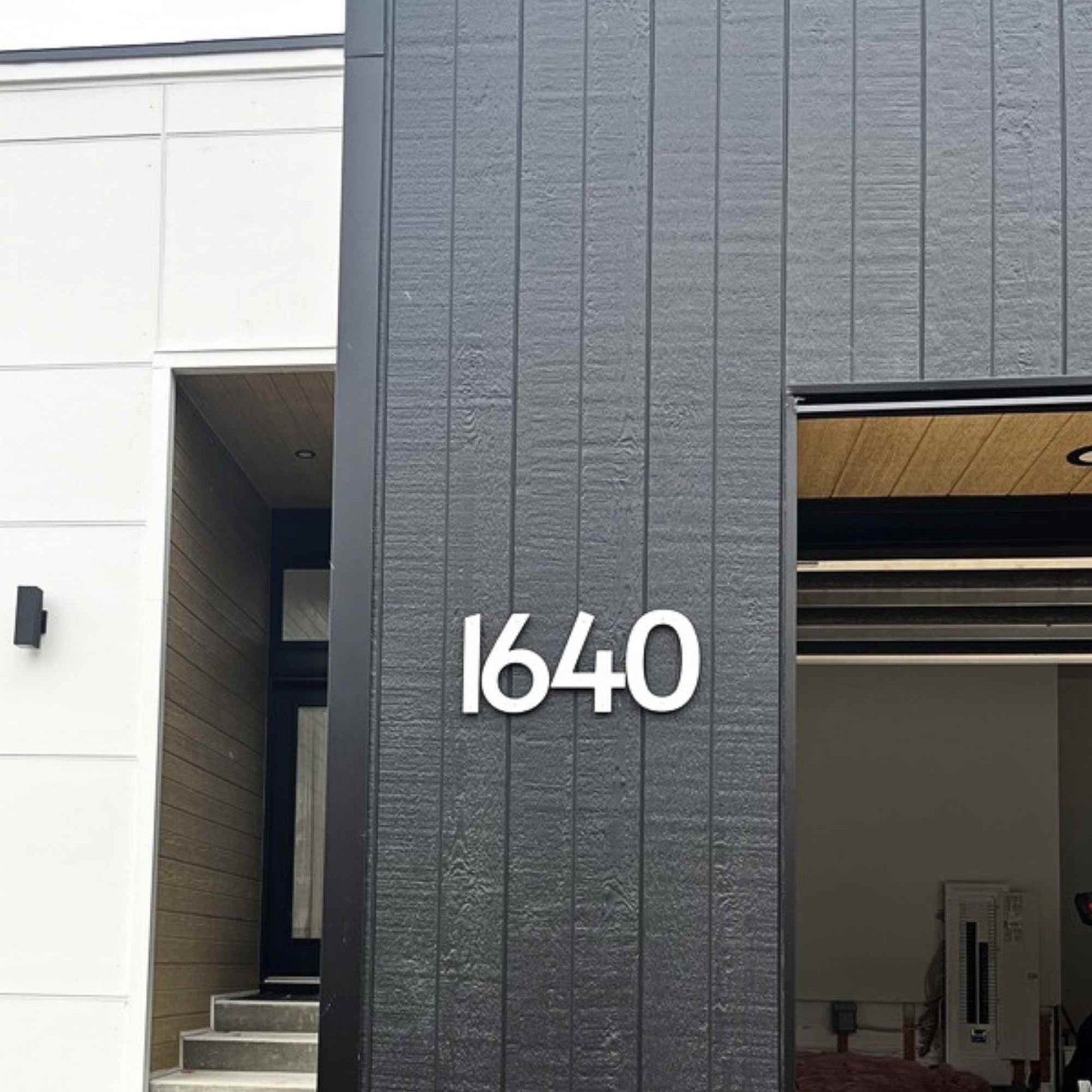 Modern building exterior with number '1640' on a gray facade