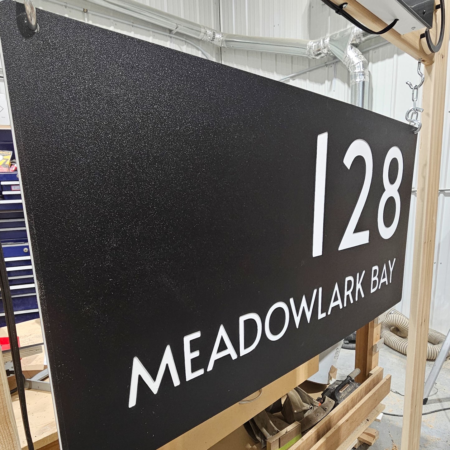 Side view of pebble finish on Engraved Address Sign with personalized name and street options