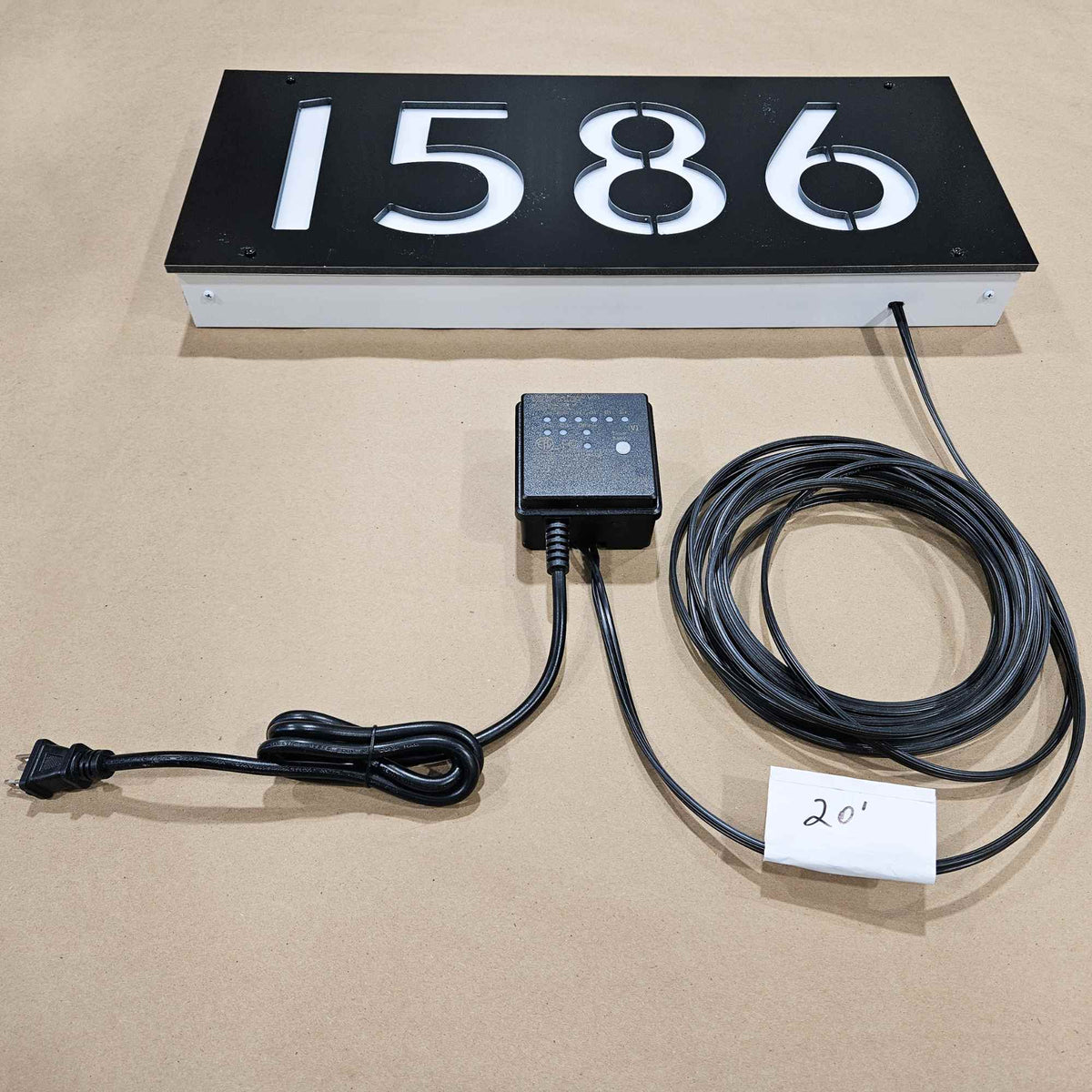 Backlit House number sign with power cable and and light sensor