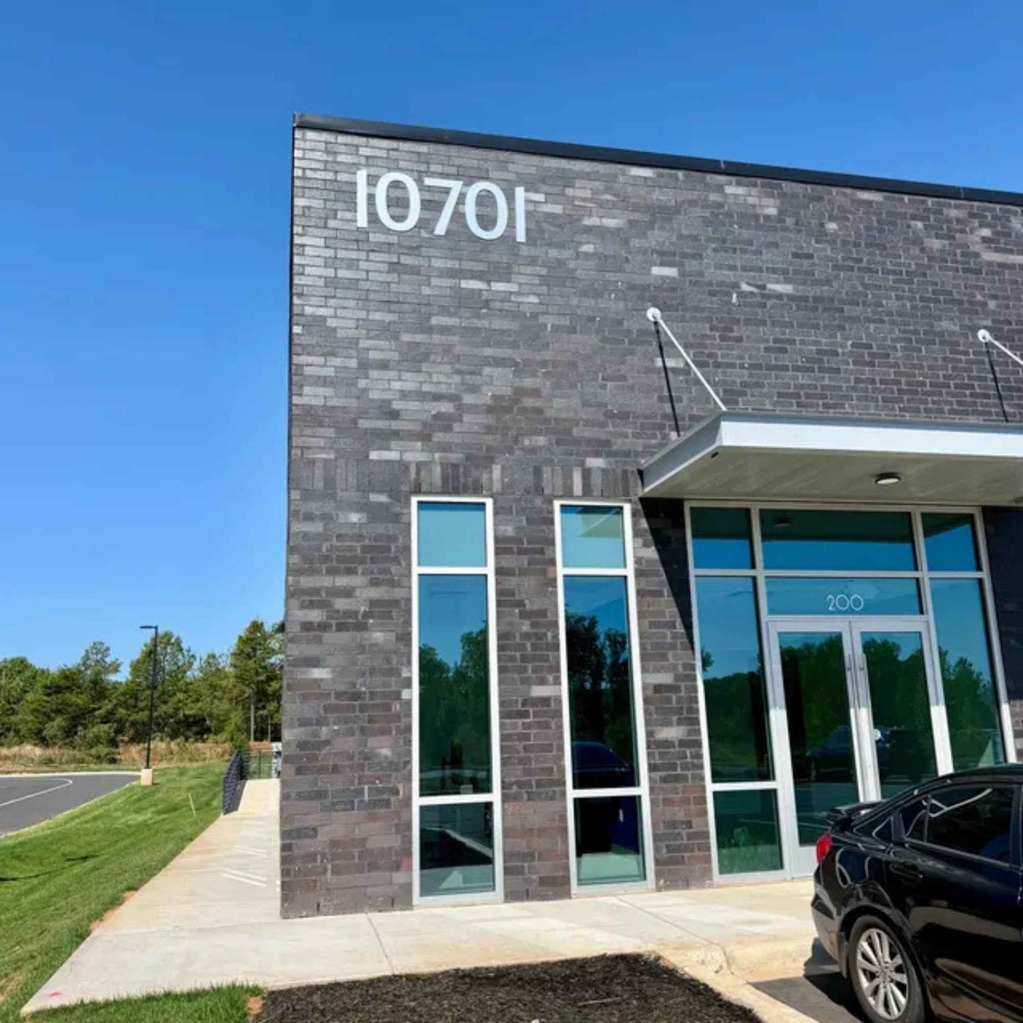 24 inch tall Address numbers in a brushed silver finish and in the CLASSIC MODERN collection style on a brick front retail or commercial space