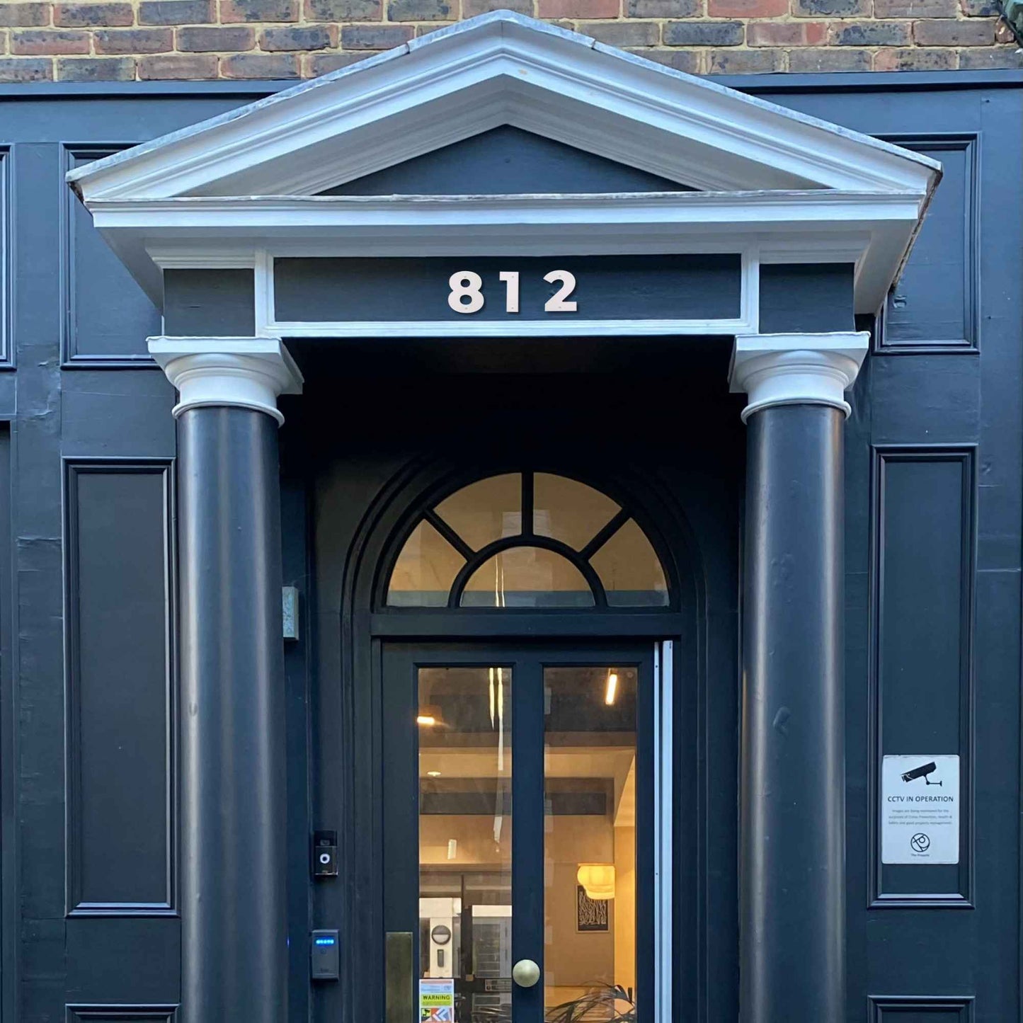 showing a mock up of how 4 inch silver BOLD RETRO address numbers would look over a door
